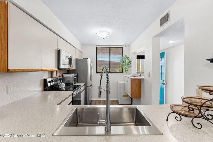 The breakfast bar connects the kitchen to the main living area and provides additional casual seating.