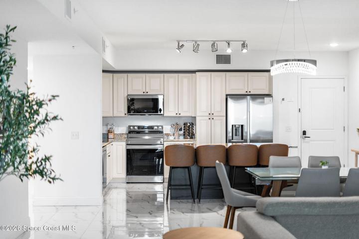 The open great room connects the living, dining and kitchen spaces in one bright and sophisticated setting.