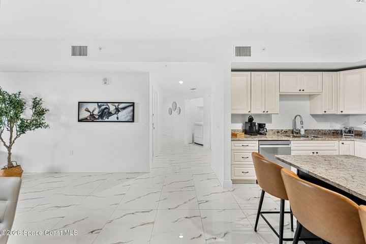 A defined hallway separates the bedroom wing from the main entertaining areas to preserve privacy throughout the residence.