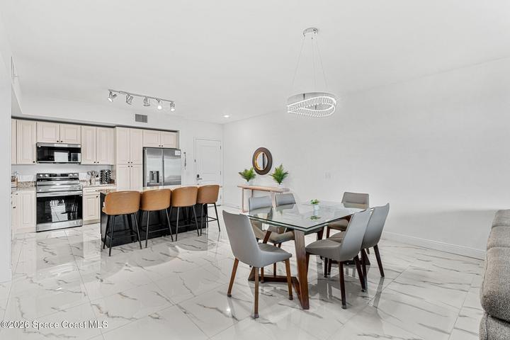 The dining area is positioned between the kitchen and living room for an open and natural entertaining flow.