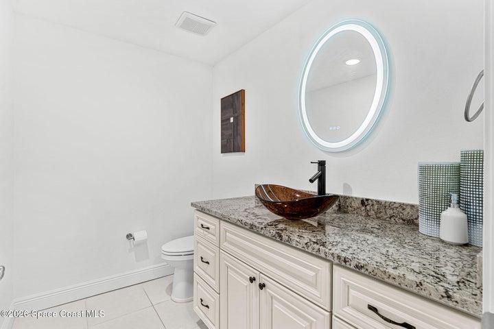 The conveniently positioned powder room serves the main living area without interrupting the privacy of the bedroom suites.