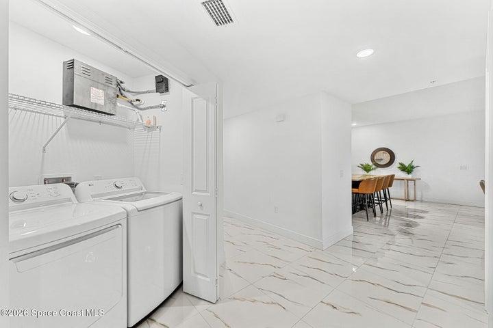 A defined hallway separates the bedroom wing from the main entertaining areas to preserve privacy throughout the residence.