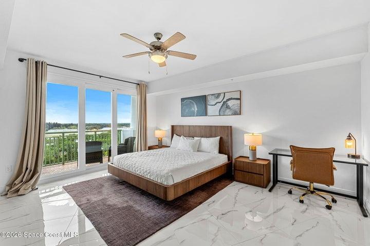 The primary bedroom provides a private ninth-floor retreat with generous proportions and elevated aviation views.
