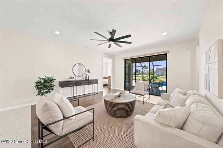 Bright family room with picture window views and easy-care flooring, an inviting space to gather in this Melbourne, FL home