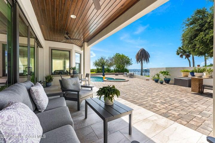 Inviting rear porch overlooking the beautiful waterfront setting