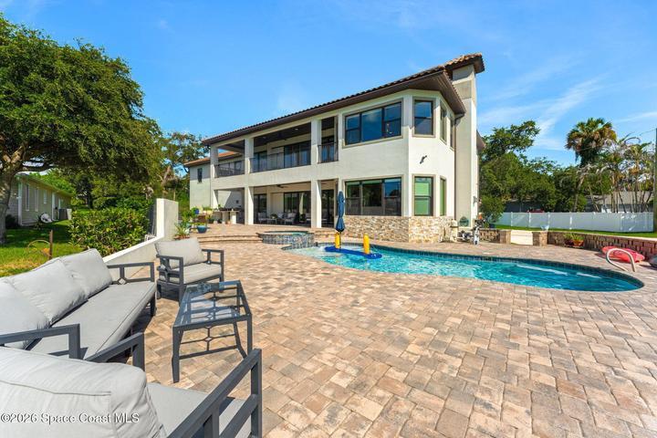 Spacious rear porch offering a comfortable retreat just steps from the pool