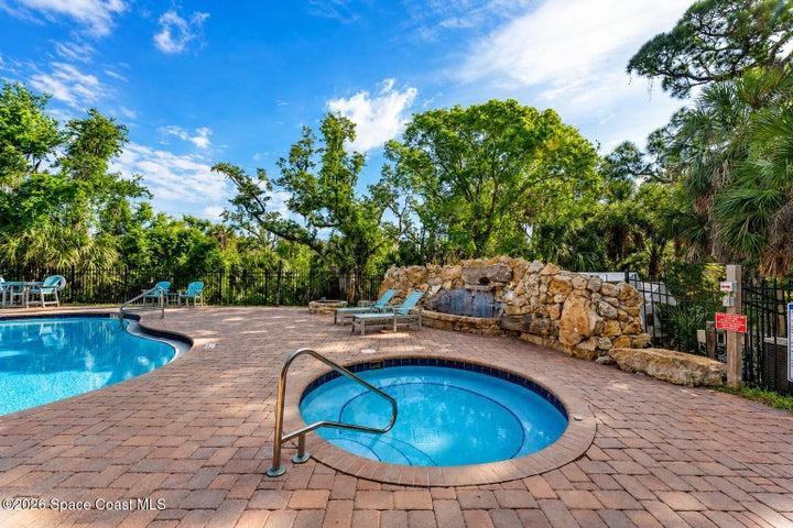 The heated resort-style pool and waterfall feature create a private escape within the River Fly-In community.