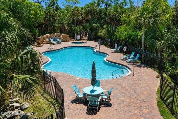 The heated resort-style pool and waterfall feature create a private escape within the River Fly-In community.