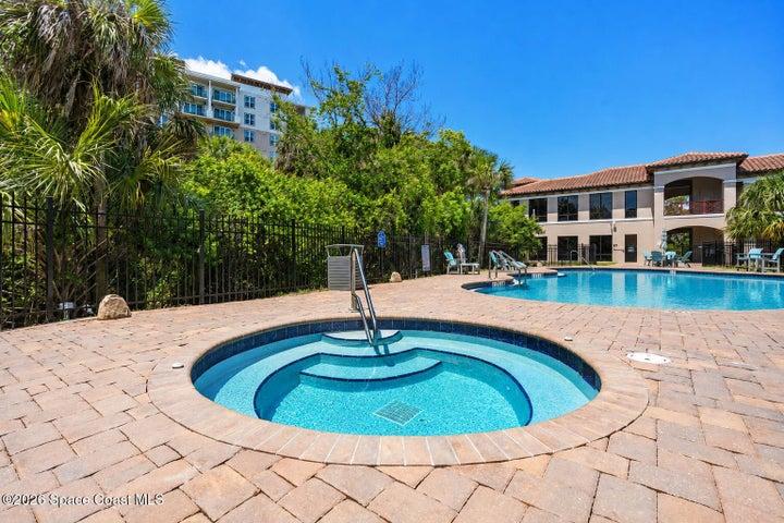 The heated resort-style pool and waterfall feature create a private escape within the River Fly-In community.