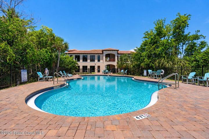 The heated resort-style pool and waterfall feature create a private escape within the River Fly-In community.