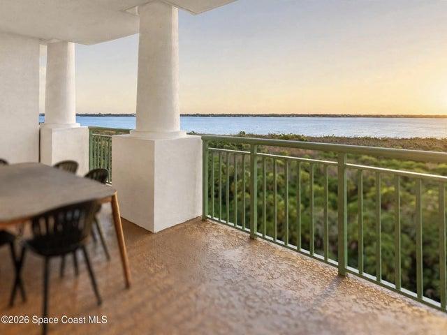 The main balcony extends the central living space outdoors with elevated runway, waterfront and conservation views.