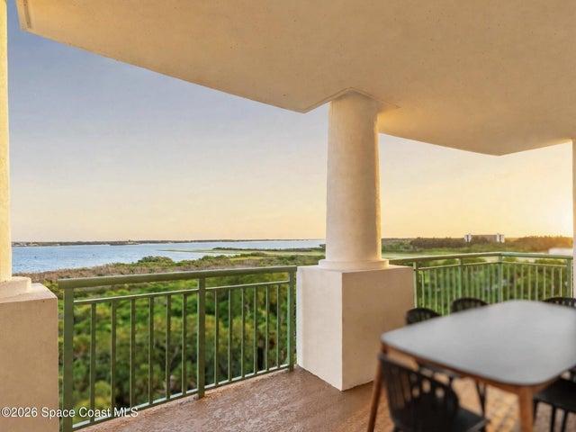 The main balcony extends the central living space outdoors with elevated runway, waterfront and conservation views.