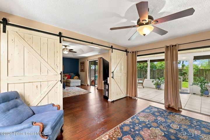 Versatile flex space with direct access to both the screened-in lanai and the central atrium, creating a bright and inviting connection to the outdoors.