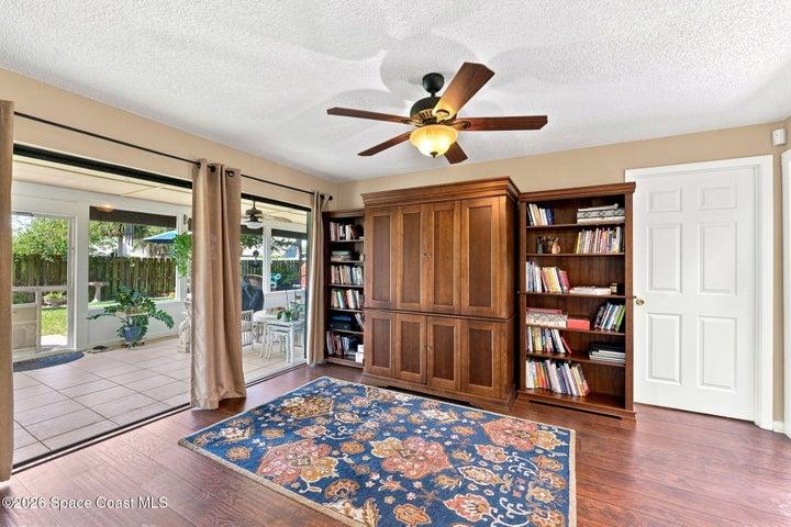 Versatile flex space with direct access to both the screened-in lanai and the central atrium, creating a bright and inviting connection to the outdoors.