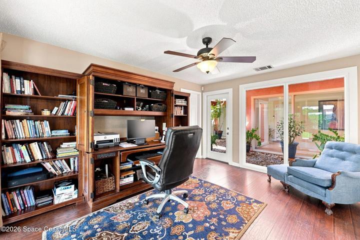 Versatile flex space with direct access to both the screened-in lanai and the central atrium, creating a bright and inviting connection to the outdoors.