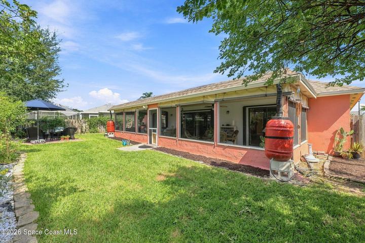 Well-maintained, fully fenced backyard featuring lush landscaping and an abundance of mature plants, creating a private and inviting outdoor retreat.