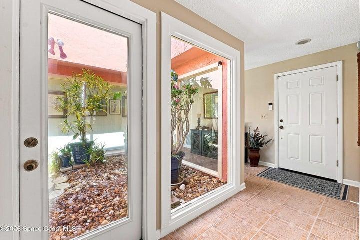 Upon entering, you’re welcomed by a beautiful central atrium, accessible from three rooms and offering an inviting connection to nature and an abundance of natural light.