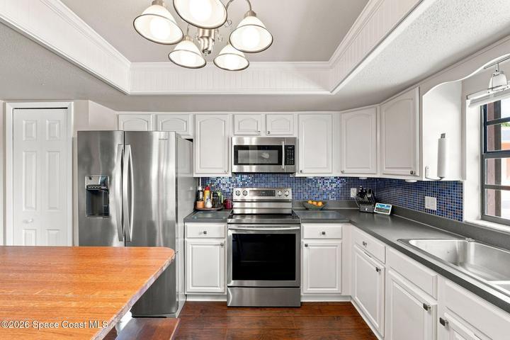 Enjoy the spacious eat-in kitchen, featuring a kitchen island with seating and an open layout that flows seamlessly into the dining room, making it easy to entertain guests while preparing a meal.
