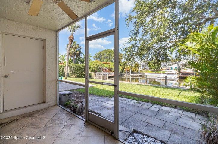 Screened back patio w/canal view and door to laundry