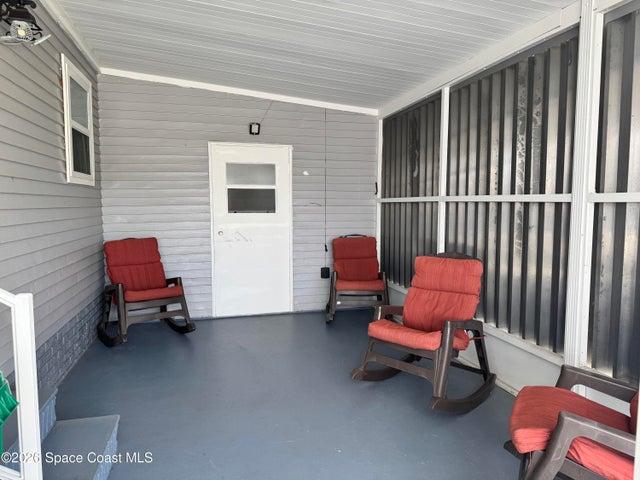 Side ground level screen porch w/hurricane shutters