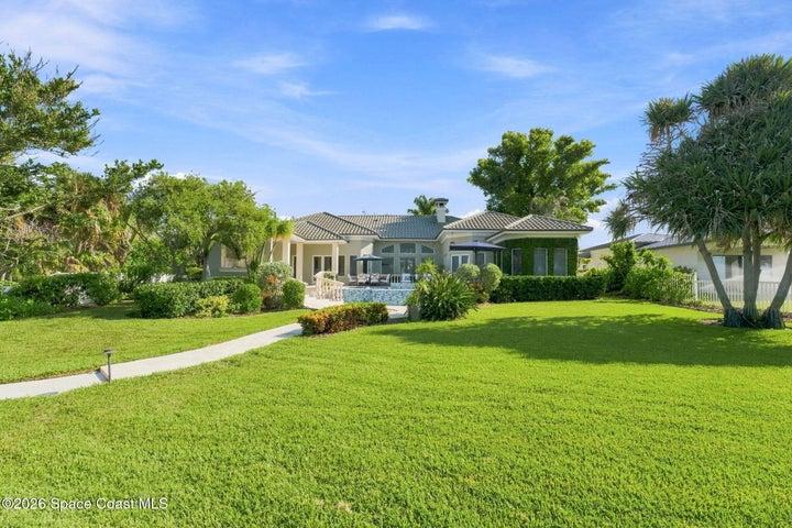 Rare Waterfront estate setting with an expansive lawn, mature tropical landscaping, and incredible outdoor space surrounding the pool and residence—all set on .78 acres.