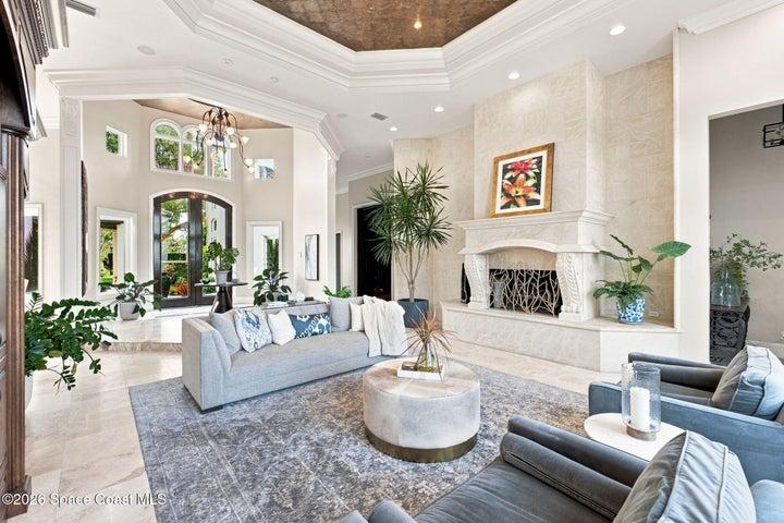 Exceptional craftsmanship takes center stage with a magnificent stone fireplace, intricate ceiling and millwork details, soaring ceilings, and a grand open design creating an impressive yet inviting living space.