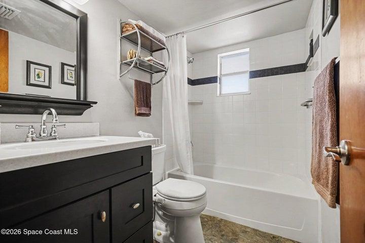 convenient guest bathroom with full tile shower