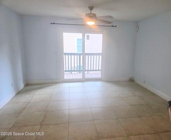 Tiled living room with Newer Sliders leads to balcony w pool view