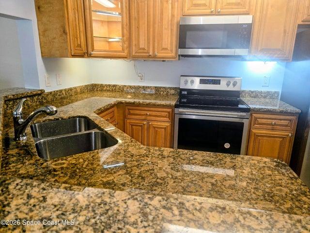 Kitchen with Granite countertops and newer appliances, including a Bosch dishwasher