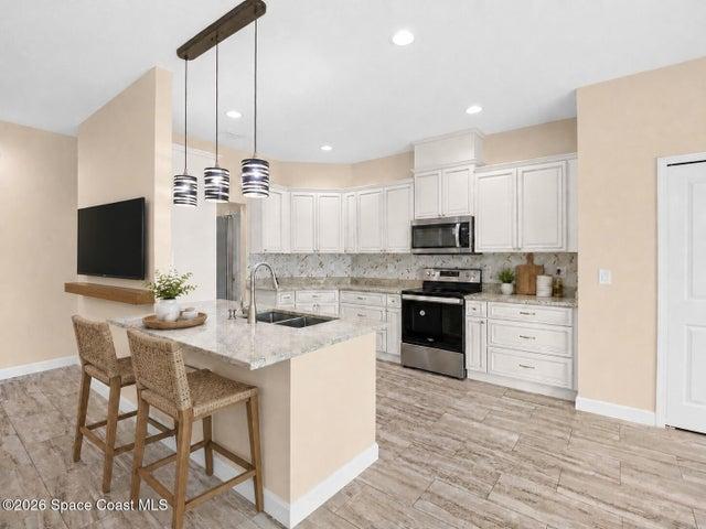 Well-appointed kitchen with ample cabinetry and counter space