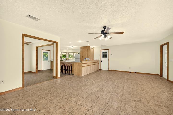 LARGE LIVING AREA, opens to dining and kitchen areas.