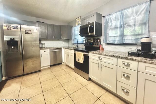 kitchen with two tone cabinets and stainless steel appliances