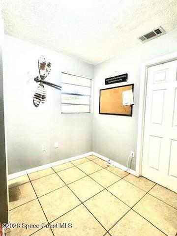 smaller room with closet, perfect for home office.