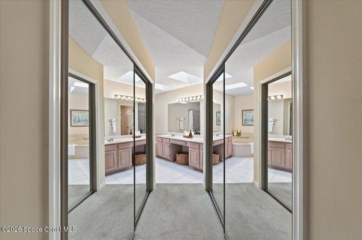 His and Her's walk-in closets leading towards the Primary Bathroom