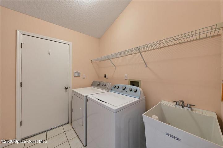 Dryer is electric but stubbed for gas too, utility sink and storage out of view.