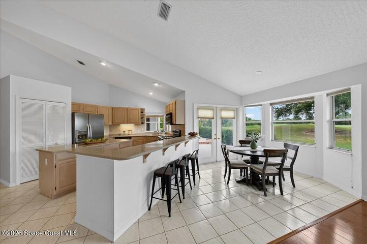 Breakfast nook with view of breakfast bar. I love all the windows in this home, offering tons of natural light and beautiful views.