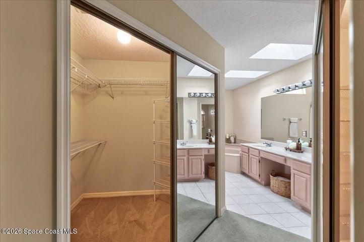 His and Her's walk-in closets leading towards the Primary Bathroom