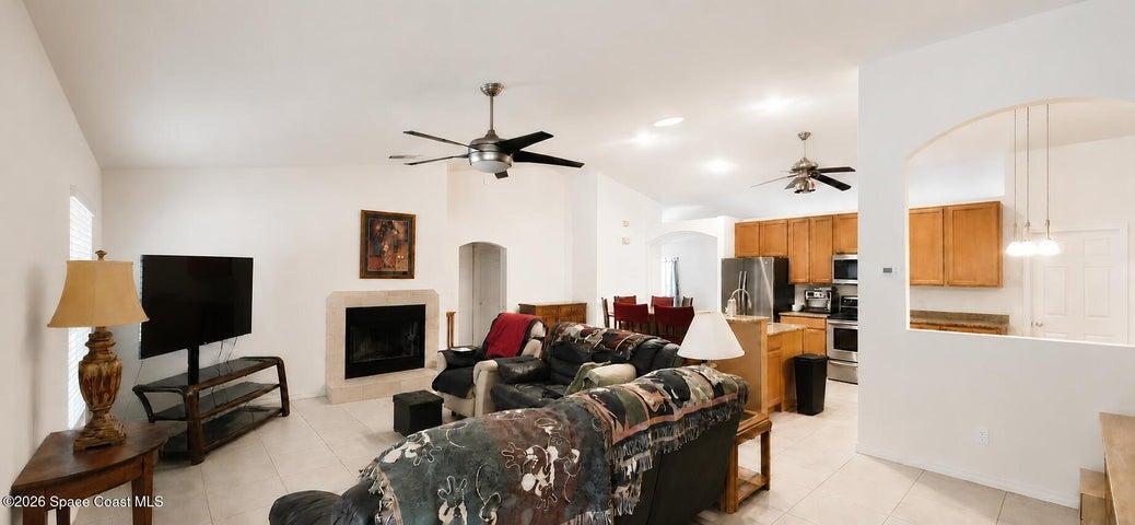 Open area living and kitchen. Digitally decluttered.