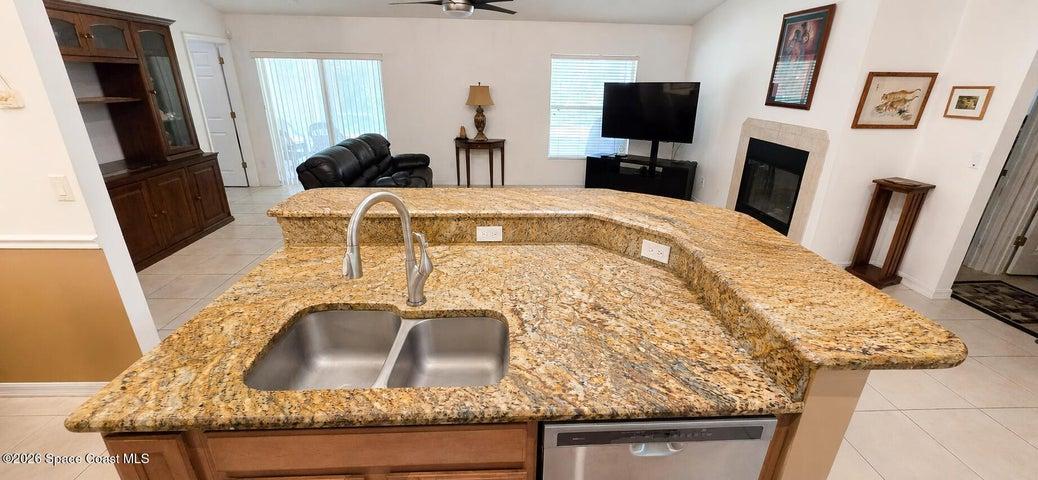 Kitchen island with granite counters. Digitally decluttered.