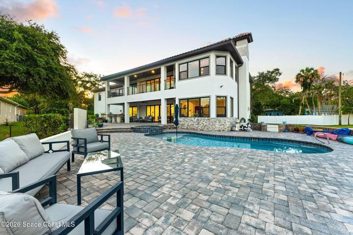 Covered rear porch overlooking the pool—perfect for relaxing or entertaining
