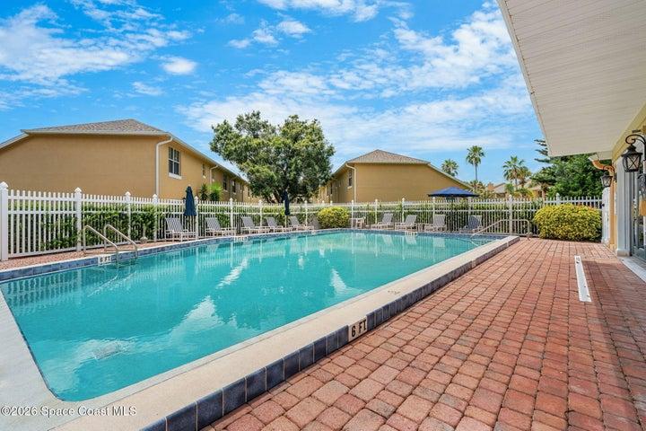 Sizable pool and deck chairs with umbrellas for shade from the Florida sun.