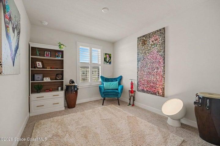 2nd bedroom with carpet & plantation shutters.