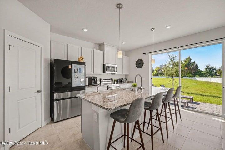 Oversized island with power accessibility & pullout double trash bin.