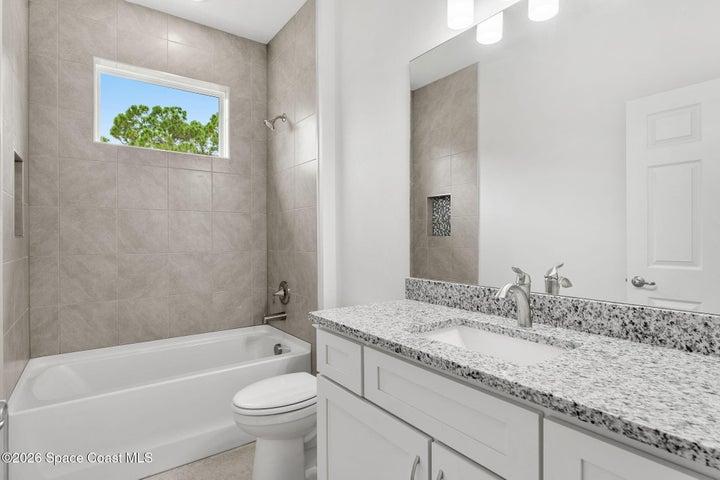 Bathroom 2- Shower with tub, granite countertops and skylight