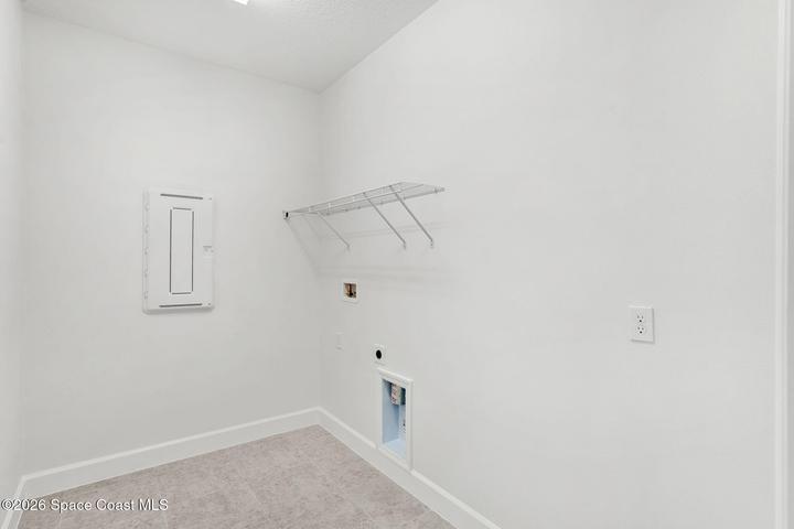 In homes Laundry Room with washer and electric dryer hookups.