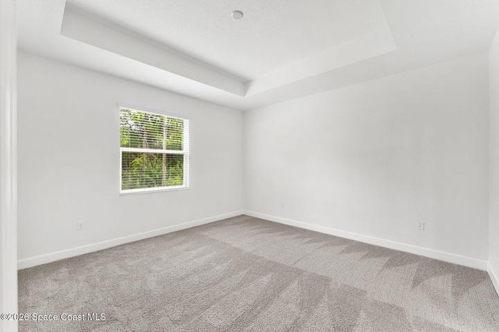 Natural light and lush greenery for added privacy in the Primary Bedroom.