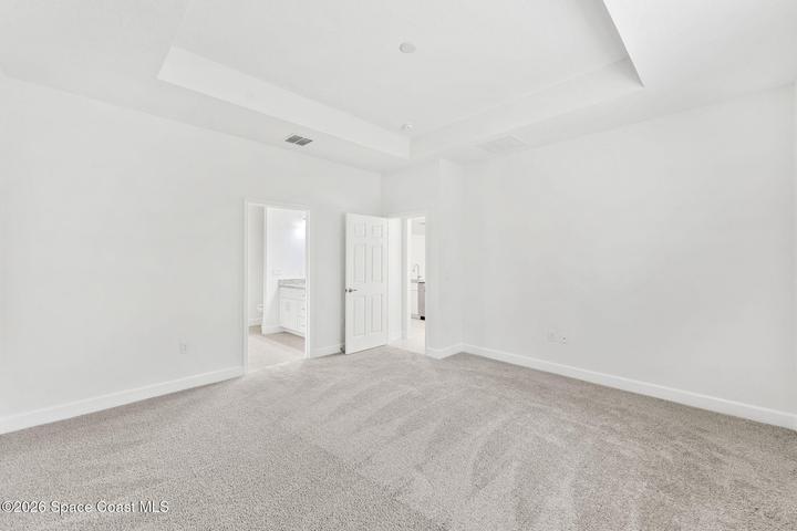 The Primary Bedroom features its own tray ceiling and carpet for added comfort.