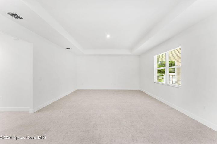 Great Room with tray ceilings and tile throughout