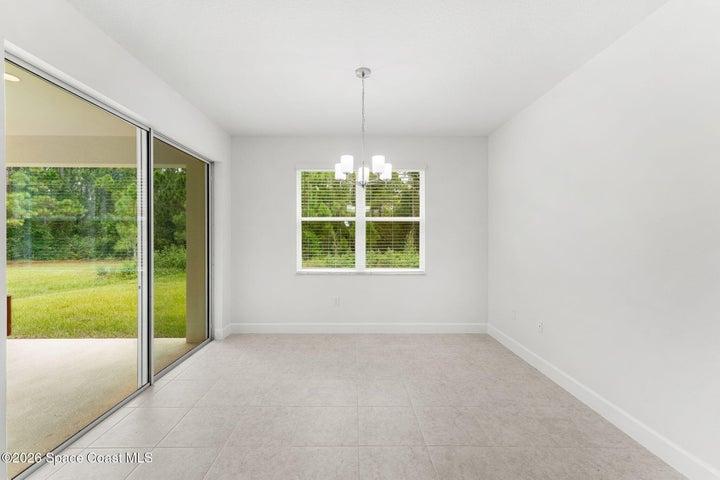 Enjoy morning coffee in the kitchen nook with the natural light and lush backyard greenery.