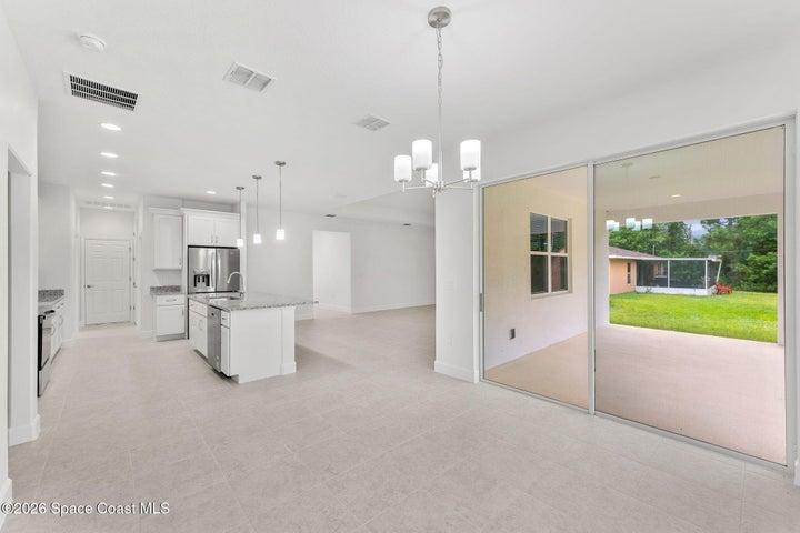 Kitchen with Kitchen Nook and sliding glass door to trussed rear patio